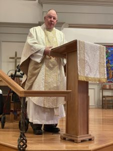 Fr. James Warnke at the lectern giving a sermon