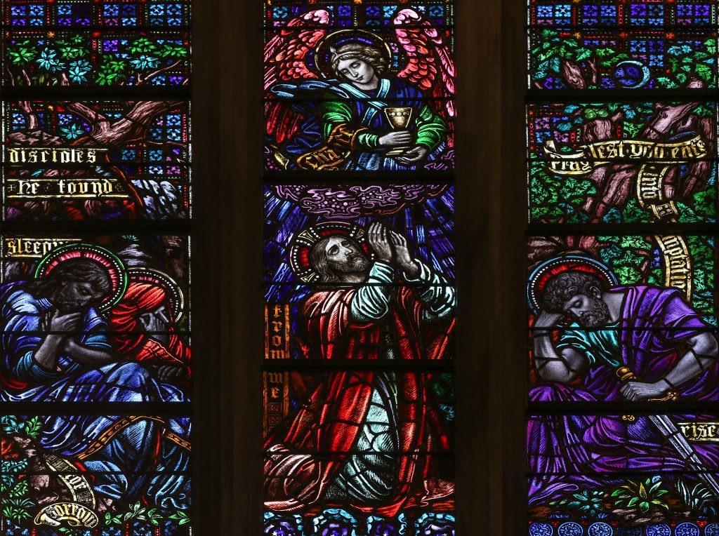 Stained glass window depicting Jesus, James and John